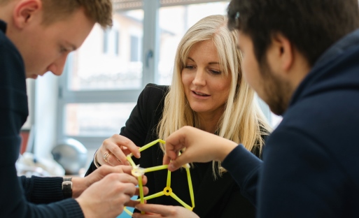 Students and teacher working on model