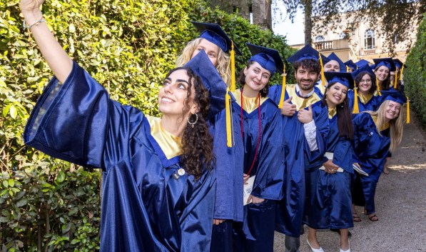 Art History alumni at graduation taking a selfie