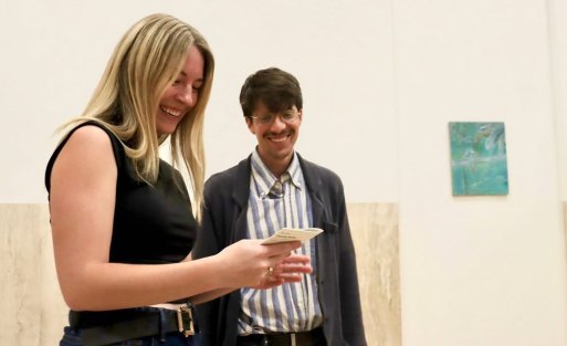 Two students talking and looking at a phone