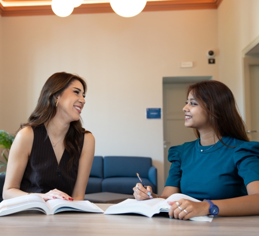 Students discussing at the desk