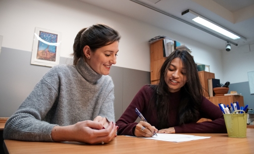 A teacher and a student looking over a paper
