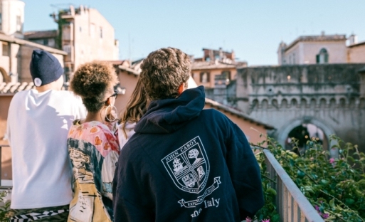 Students on the terrace of the Guarini Campus looking at Porta Settimiana