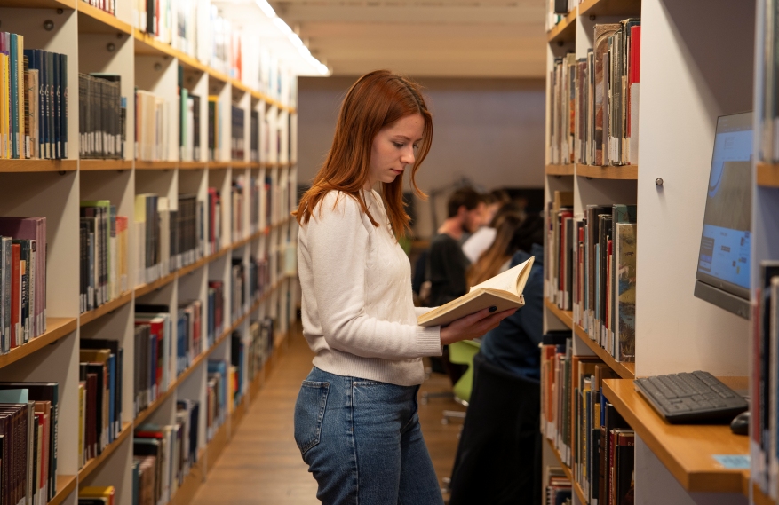 Student reading a book in the Frohring Library