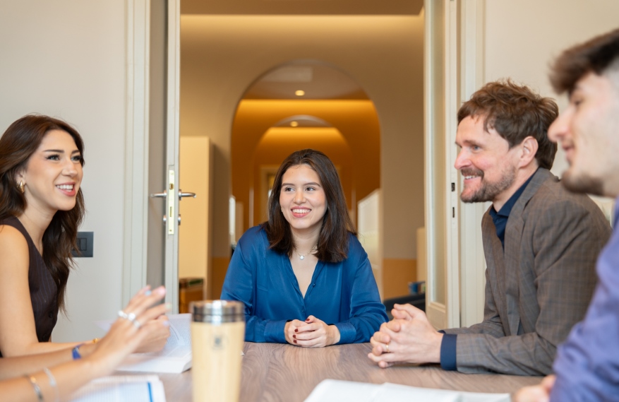 Students and professor at a table