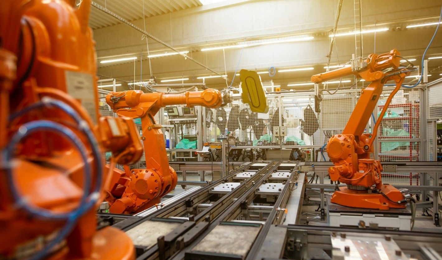 Factory filled with lots of orange machines by Simon Kadula