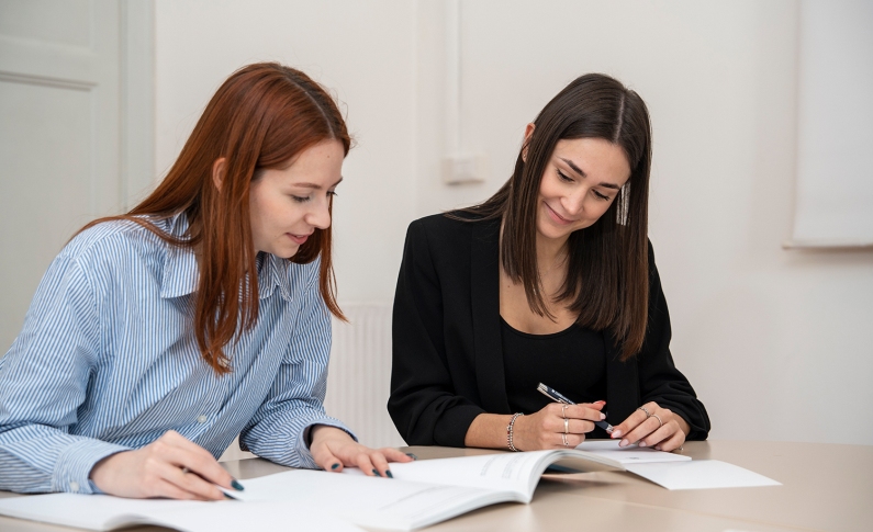 Students looking at books together